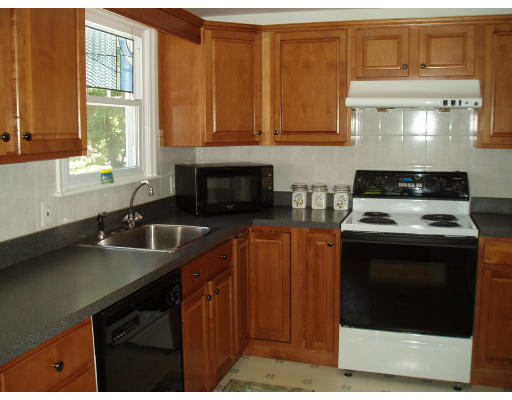 22 Warren Road Sudbury, MA 01776 - Photo 7 of 9 a kitchen with stainless steel appliances a stove a sink and a microwave