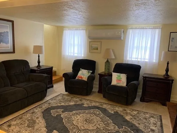 a living room with furniture lamp and rug