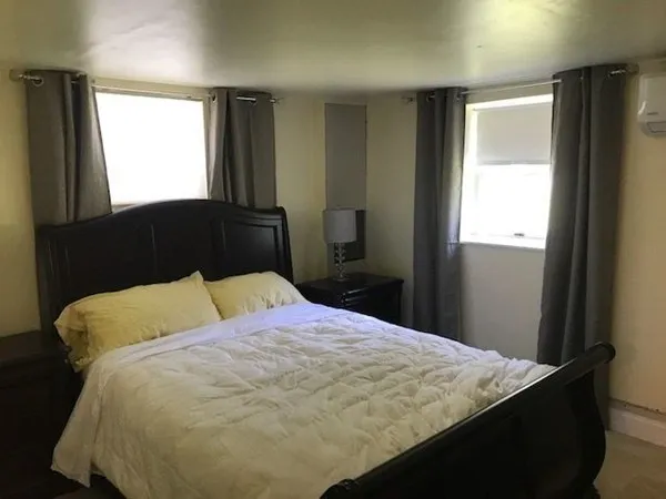 a bedroom with a bed and window