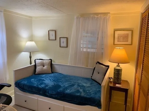 a bedroom with a bed and a lamp