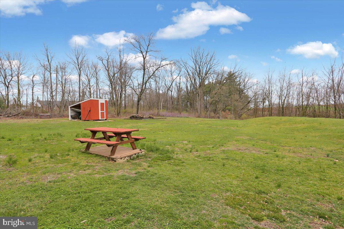1613 Shoey Road, Unit A Mohrsville, PA 19541 - Photo 14 of 17 a backyard of a house with table and chairs