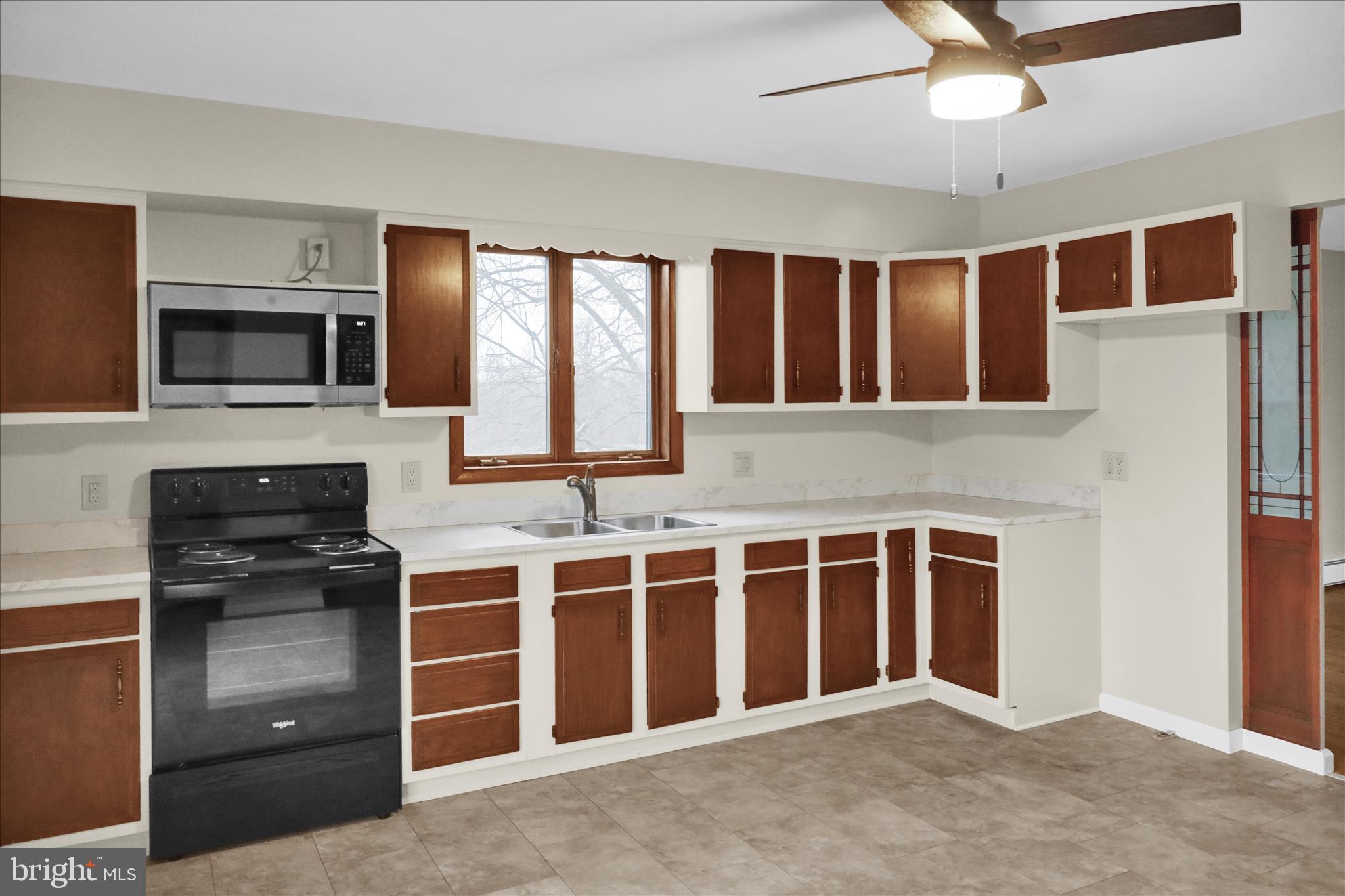 1613 Shoey Road, Unit A Mohrsville, PA 19541 - Photo 3 of 17 a view of an empty room with a kitchen