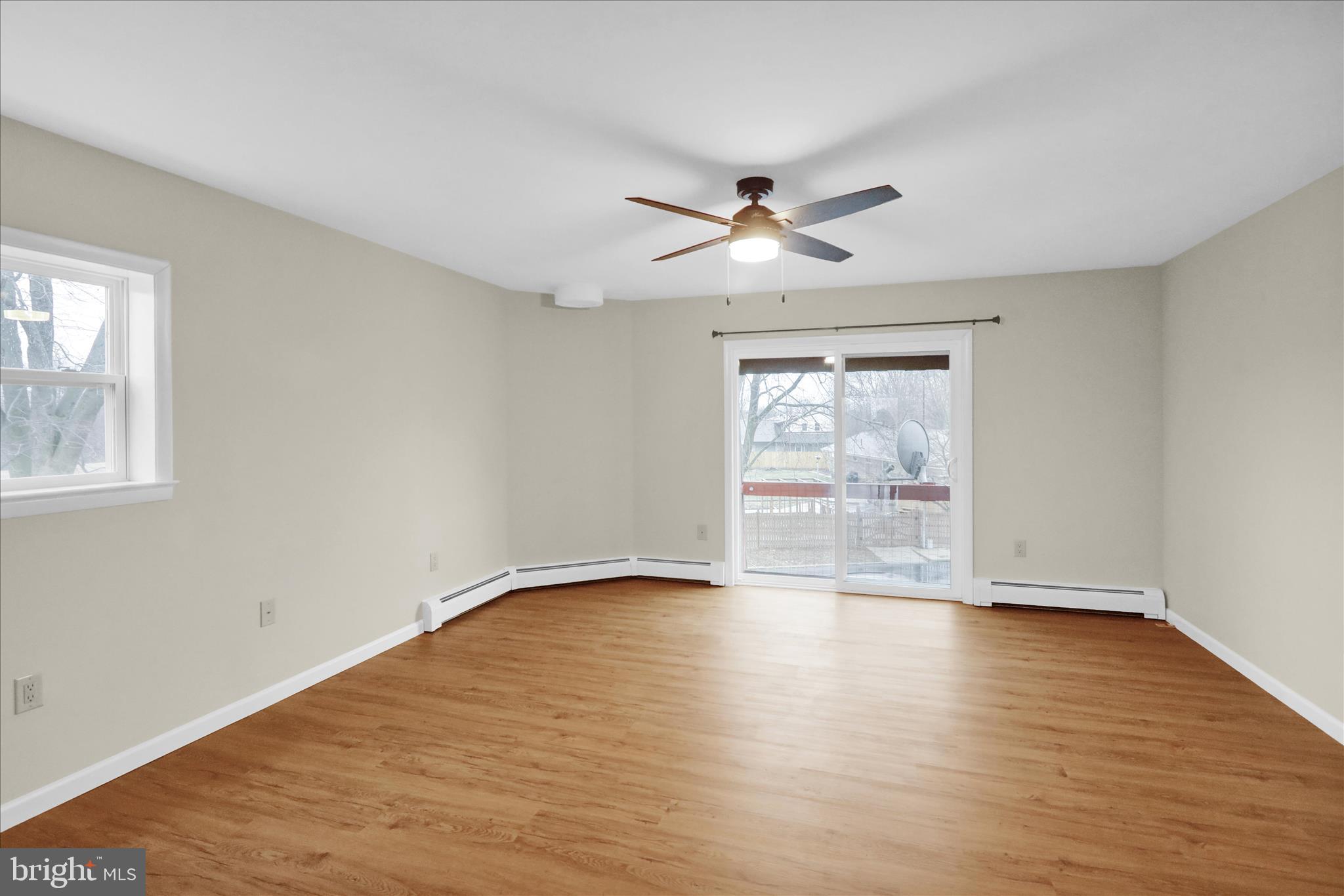 1613 Shoey Road, Unit A Mohrsville, PA 19541 - Photo 5 of 17 a view of empty room with wooden floor and fan