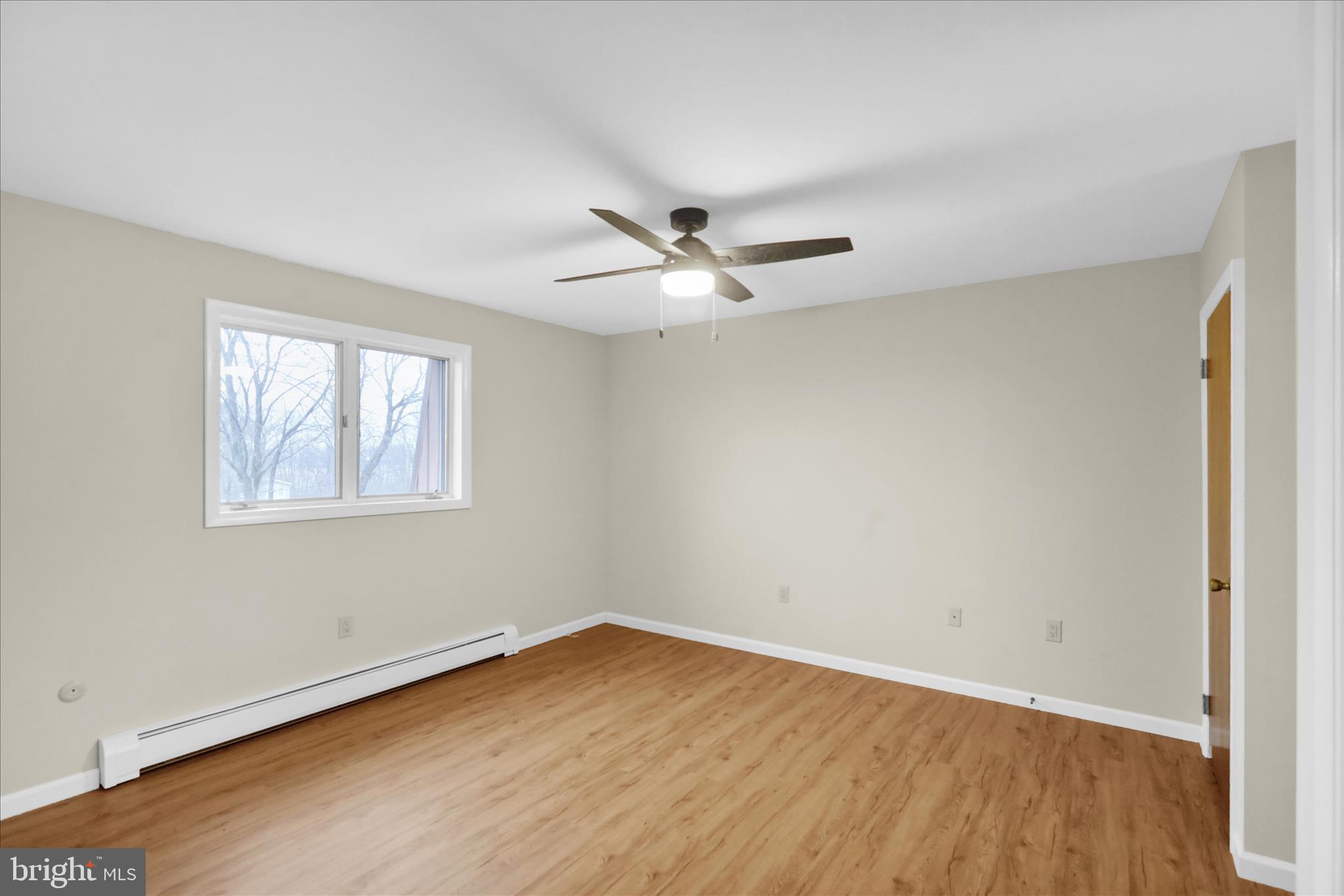 1613 Shoey Road, Unit A Mohrsville, PA 19541 - Photo 7 of 17 an empty room with wooden floor and windows