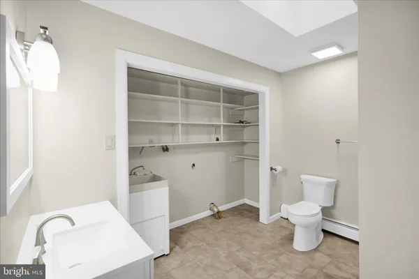 a bathroom with a toilet and a sink