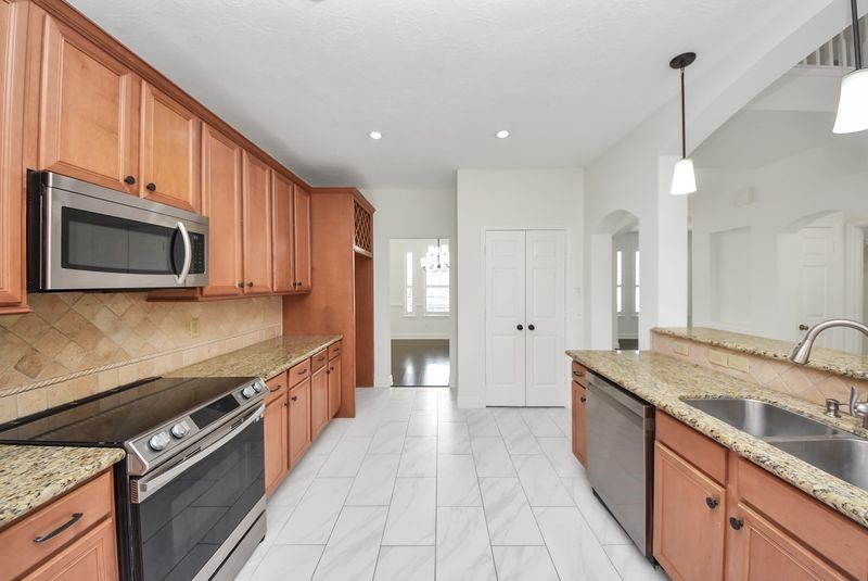 20831 Deauville Drive Spring, TX 77388 - Photo 18 of 42 The view from the kitchen into the formal dining room.