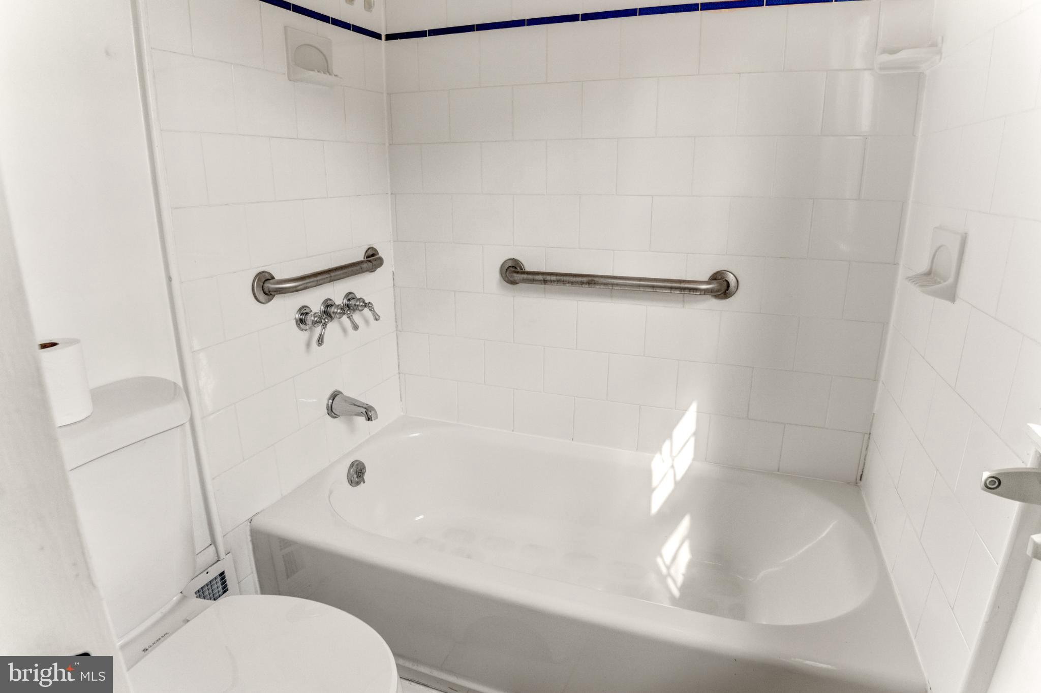 3106 Burgundy Road Alexandria, VA 22303 - Photo 18 of 24 a white bath tub sitting next to a white toilet and sink