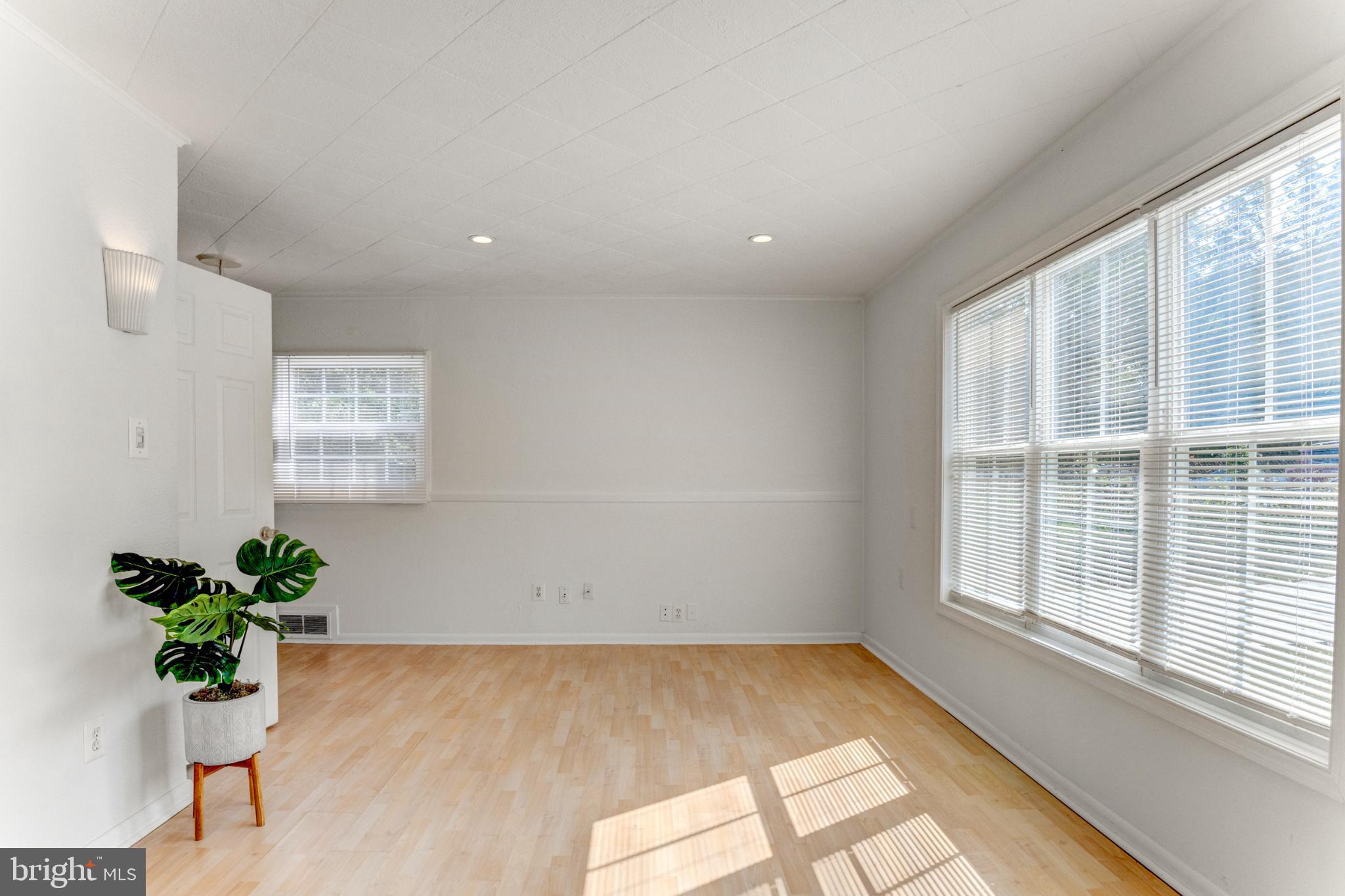 3106 Burgundy Road Alexandria, VA 22303 - Photo 3 of 24 an empty room with windows and flowers