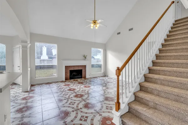 a view of entryway and hall with a fireplace