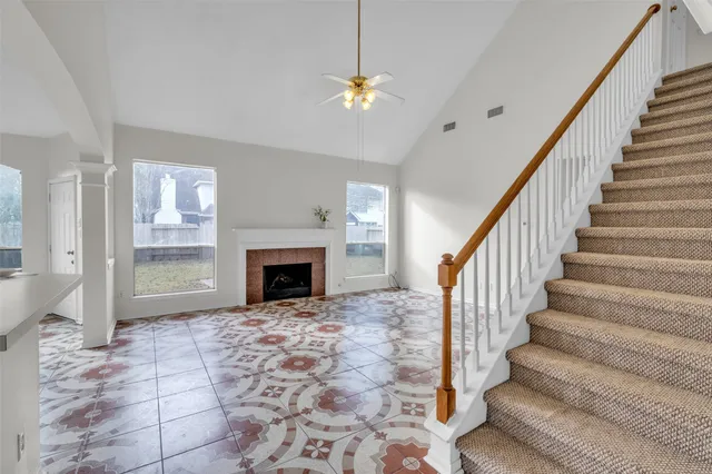 a view of entryway and hall with a fireplace