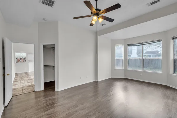 wooden floor in an empty room with a window