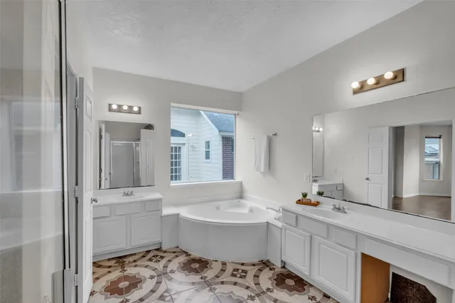 a bathroom with a bathtub a sink and a window