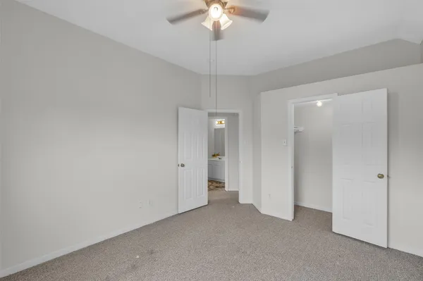 a view of a room with a chandelier fan