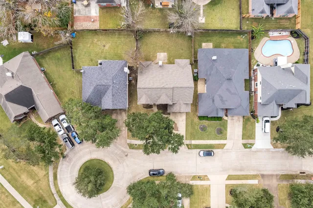 an aerial view of residential houses with outdoor space and lake view
