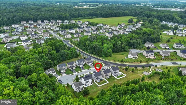 an aerial view of a residential houses with outdoor space and street view