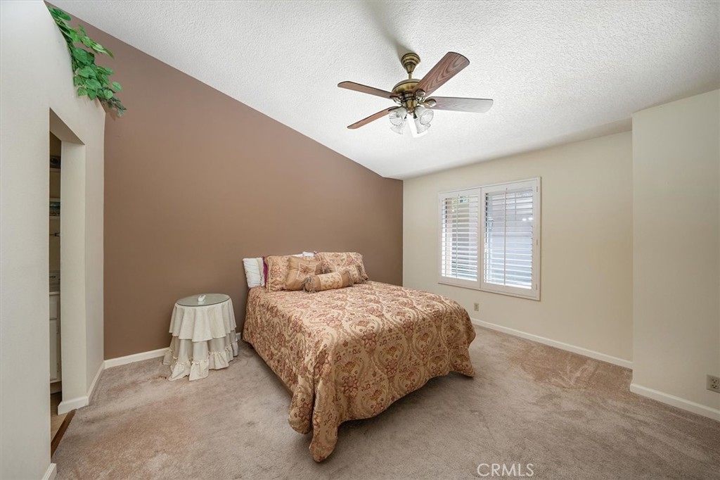 22713 Copper Hill Drive, Unit 42 Saugus, CA 91350 - Photo 21 of 32 a bedroom with a bed and a window