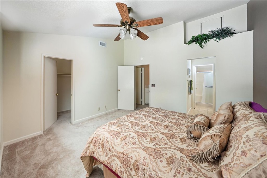 22713 Copper Hill Drive, Unit 42 Saugus, CA 91350 - Photo 22 of 32 a bed room with a bed and a chandelier