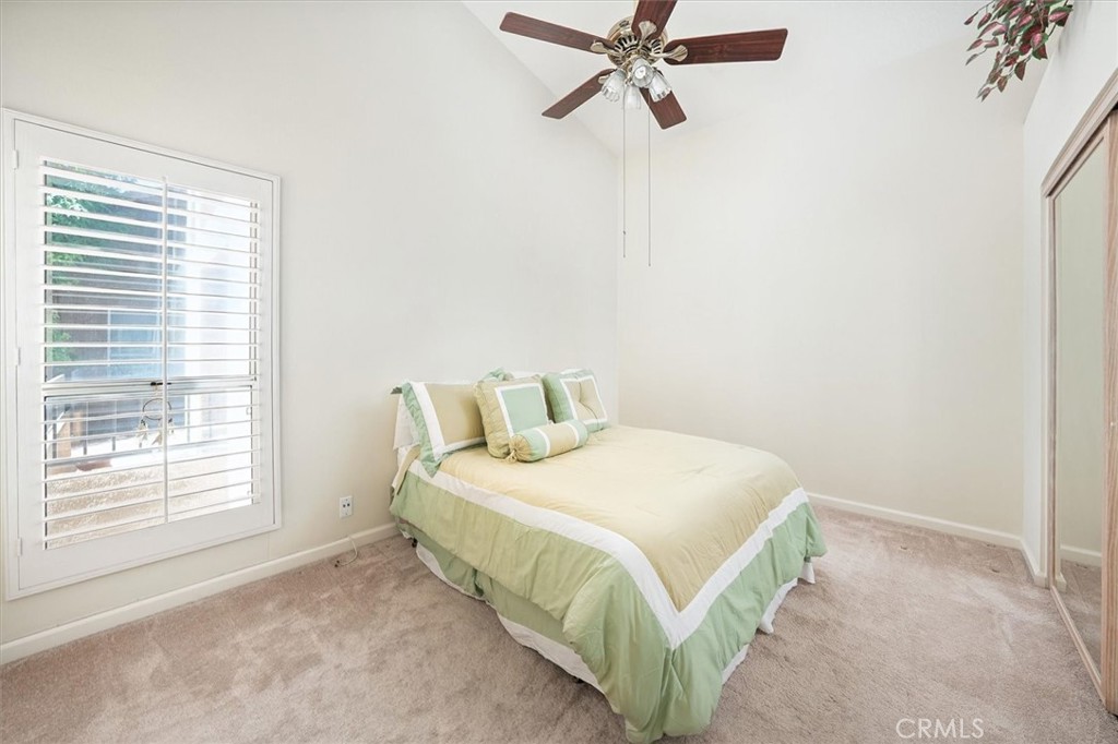 22713 Copper Hill Drive, Unit 42 Saugus, CA 91350 - Photo 25 of 32 a bedroom with a bed and window
