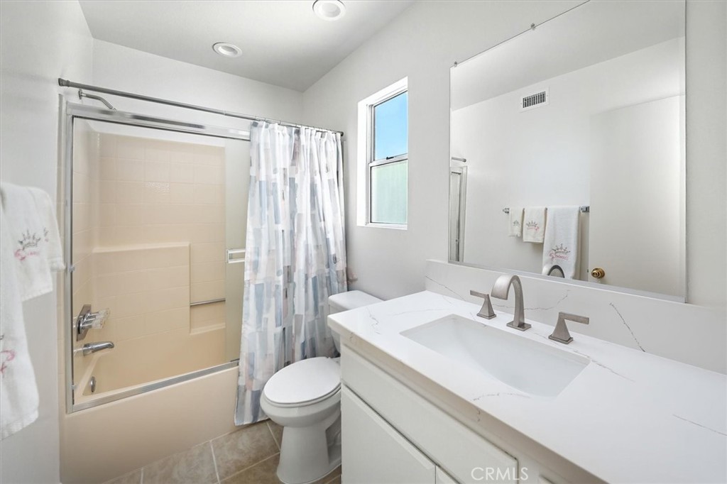 22713 Copper Hill Drive, Unit 42 Saugus, CA 91350 - Photo 27 of 32 a bathroom with a sink toilet and shower