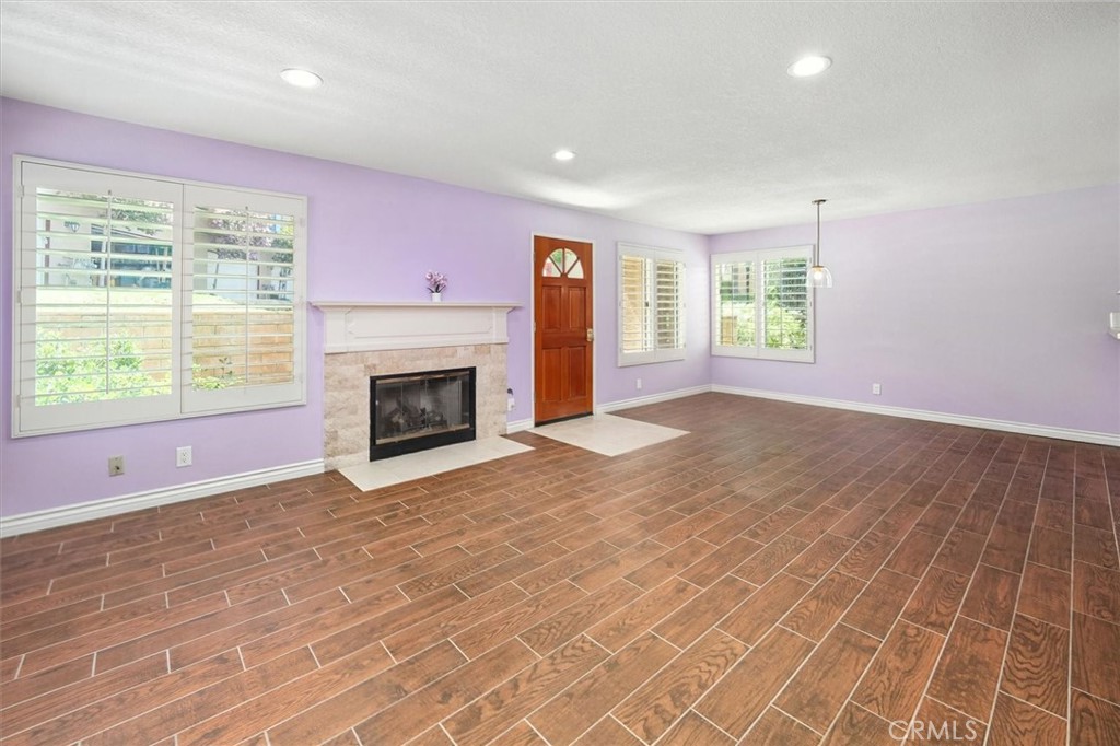 22713 Copper Hill Drive, Unit 42 Saugus, CA 91350 - Photo 9 of 32 an empty room with windows and fireplace