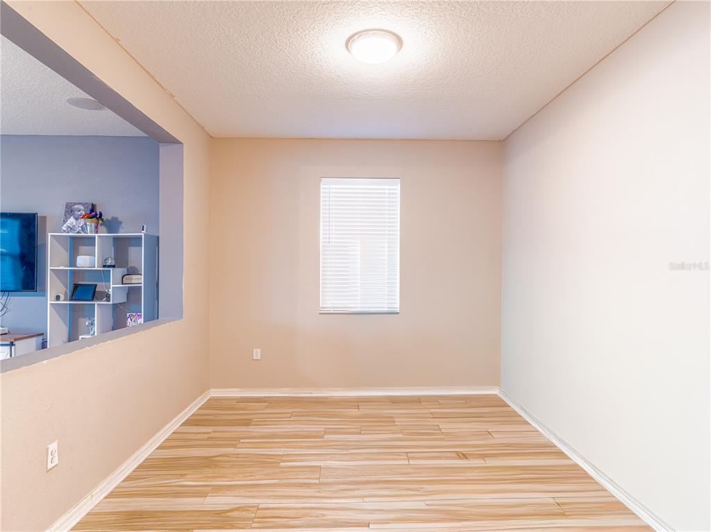 4504 Orchard Grove Road St. Cloud, FL 34772 - Photo 13 of 29 a view of empty room with wooden floor and fan