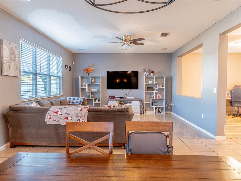 4504 Orchard Grove Road St. Cloud, FL 34772 - Photo 16 of 29 a living room with furniture and a flat screen tv