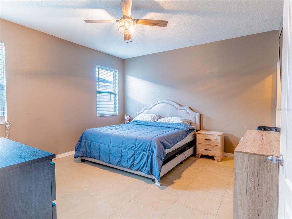 4504 Orchard Grove Road St. Cloud, FL 34772 - Photo 18 of 29 a bedroom with a bed and a window