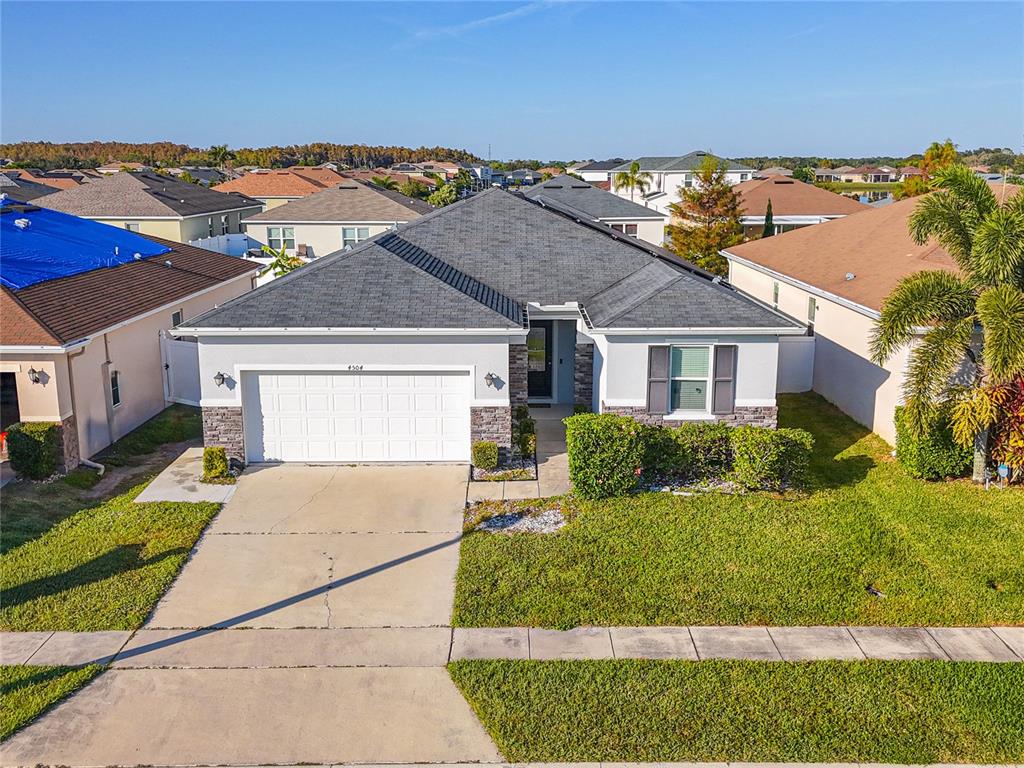 4504 Orchard Grove Road St. Cloud, FL 34772 - Photo 2 of 29 a front view of a house with a yard