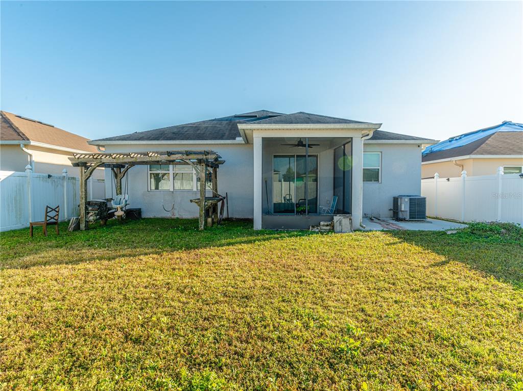 4504 Orchard Grove Road St. Cloud, FL 34772 - Photo 24 of 29 a view of a house with a backyard