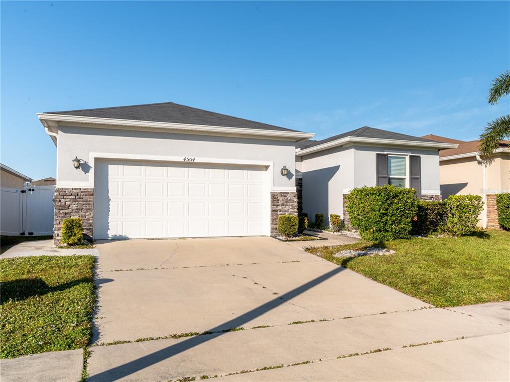 4504 Orchard Grove Road St. Cloud, FL 34772 - Photo 25 of 29 a front view of a house with a yard
