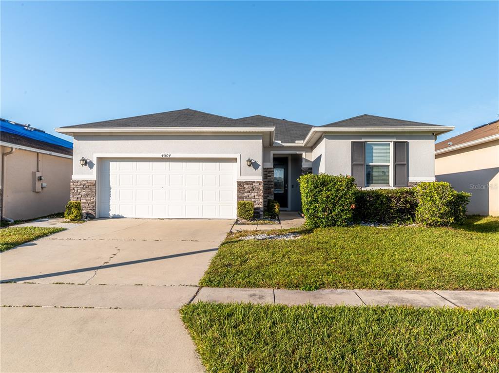 4504 Orchard Grove Road St. Cloud, FL 34772 - Photo 26 of 29 a front view of a house with a yard