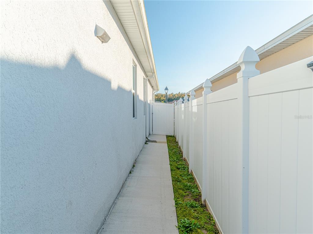 4504 Orchard Grove Road St. Cloud, FL 34772 - Photo 29 of 29 a view of a pathway of a building with a small yard
