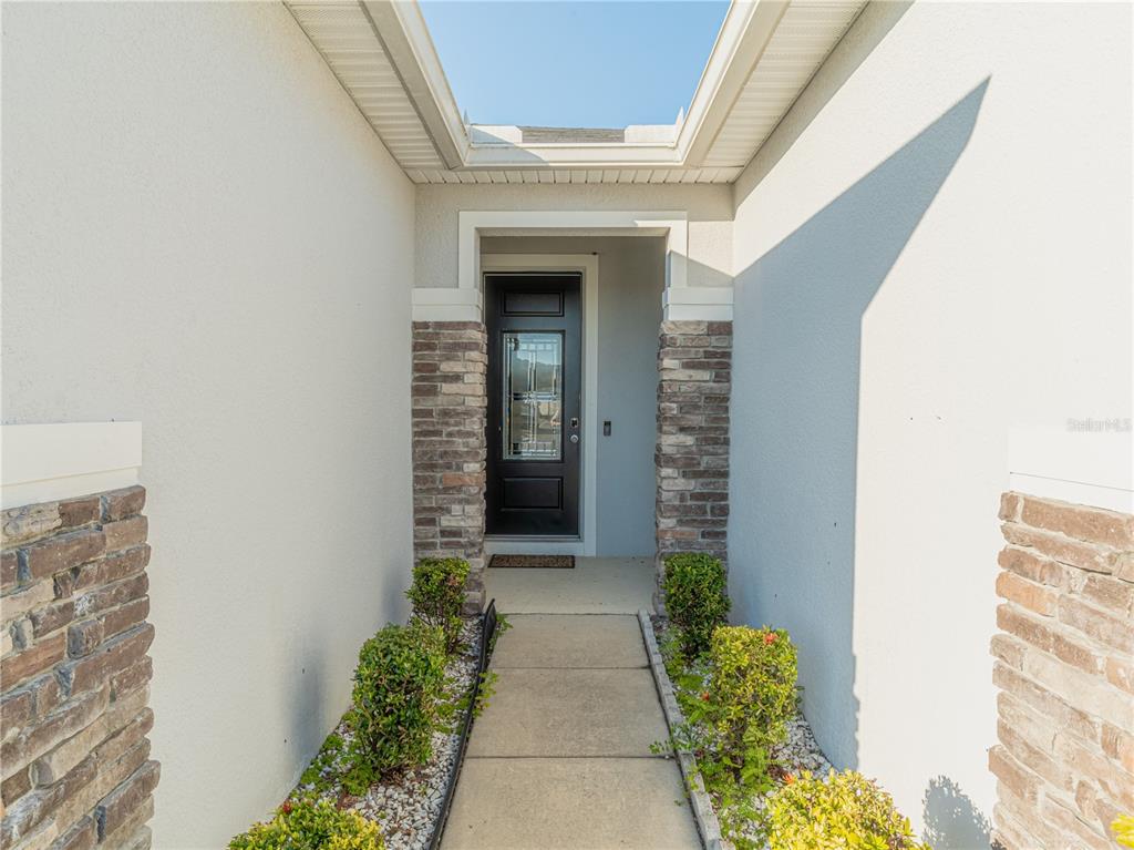 4504 Orchard Grove Road St. Cloud, FL 34772 - Photo 8 of 29 a view of a pathway besides a building