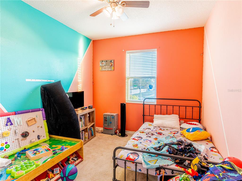 4504 Orchard Grove Road St. Cloud, FL 34772 - Photo 10 of 29 a bedroom with furniture and a wooden floor