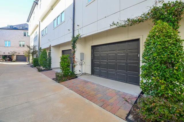a view of a tennis ground with large trees