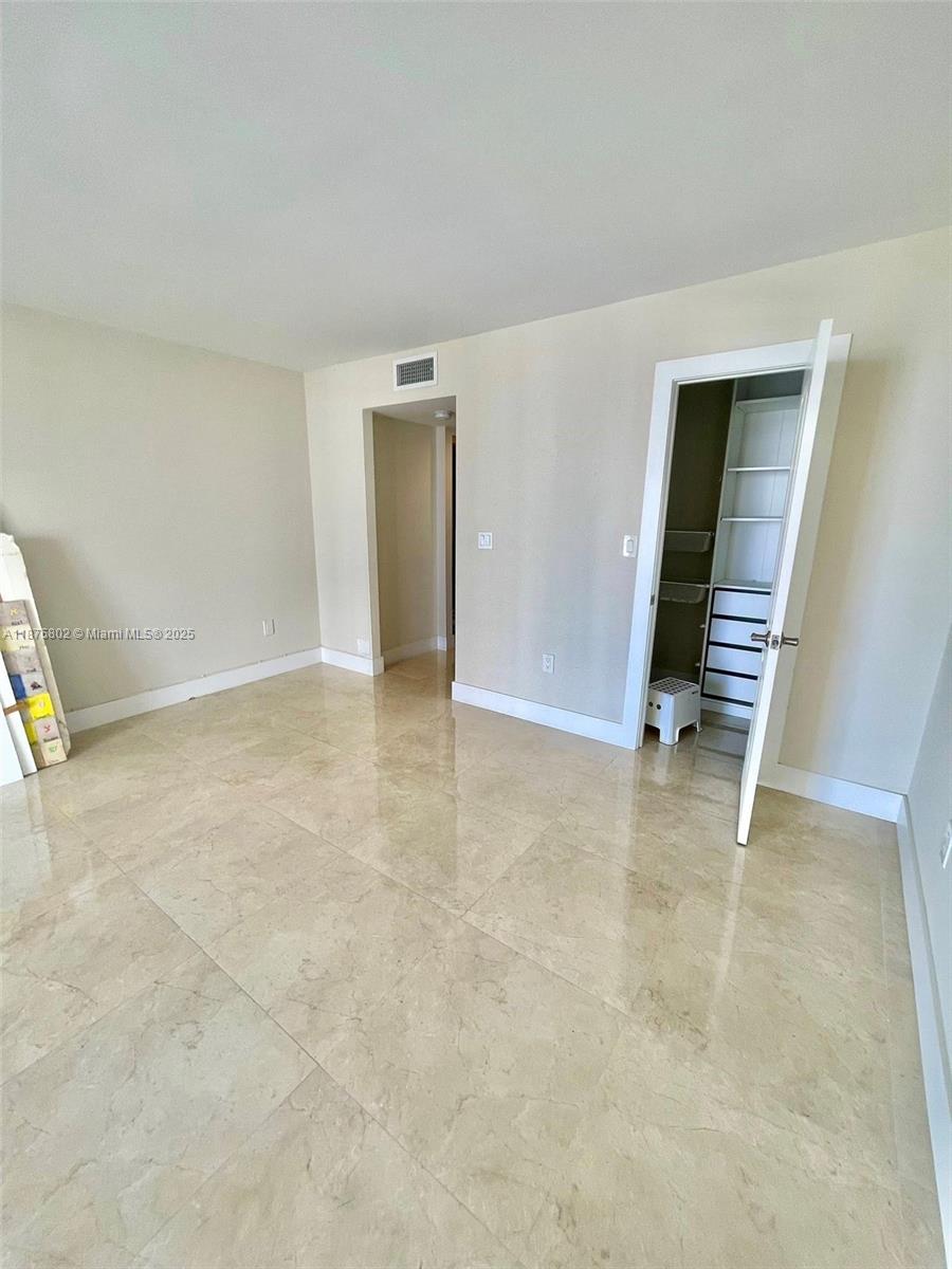 2851 Northeast 183rd Street, Unit 802E Aventura, FL 33160 - Photo 12 of 37 an empty room with closet