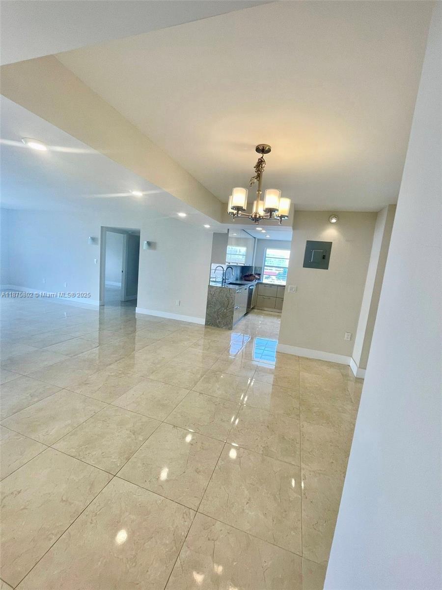 2851 Northeast 183rd Street, Unit 802E Aventura, FL 33160 - Photo 15 of 37 a view of a livingroom with furniture and chandelier