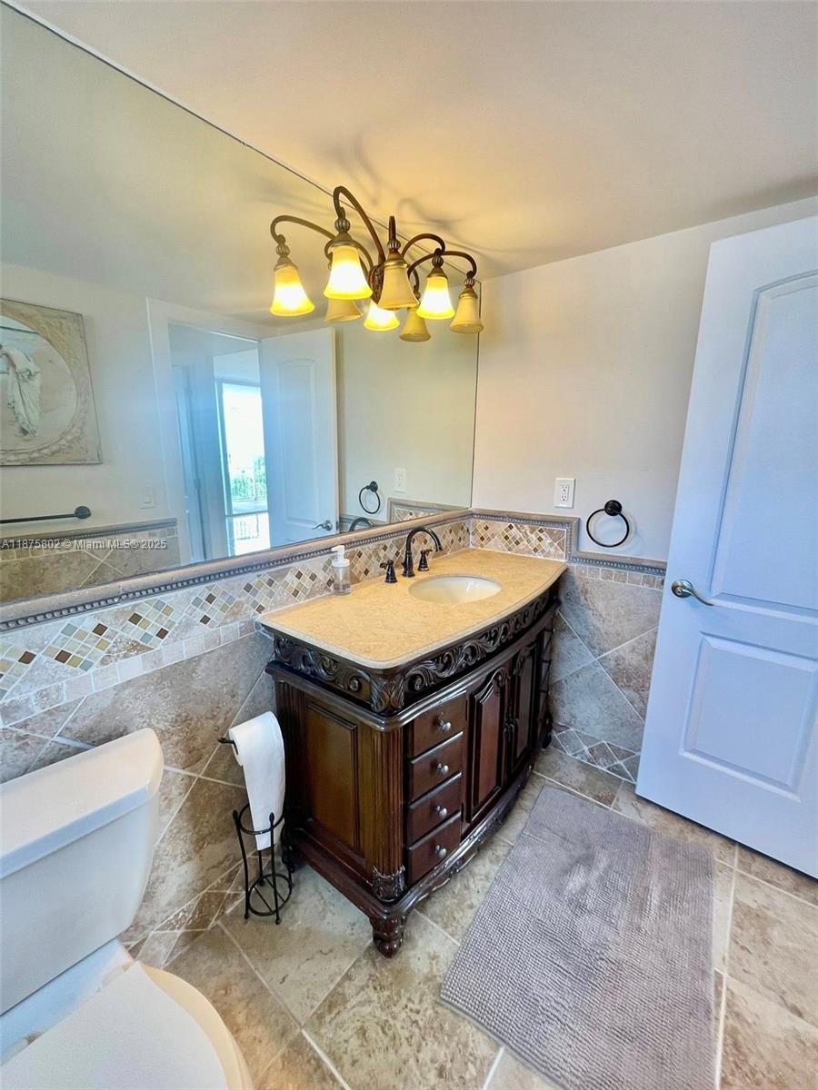 2851 Northeast 183rd Street, Unit 802E Aventura, FL 33160 - Photo 16 of 37 a spacious bathroom with a sink a bathtub and a mirror