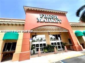 2851 Northeast 183rd Street, Unit 802E Aventura, FL 33160 - Photo 27 of 37 a front view of a building with retail shops