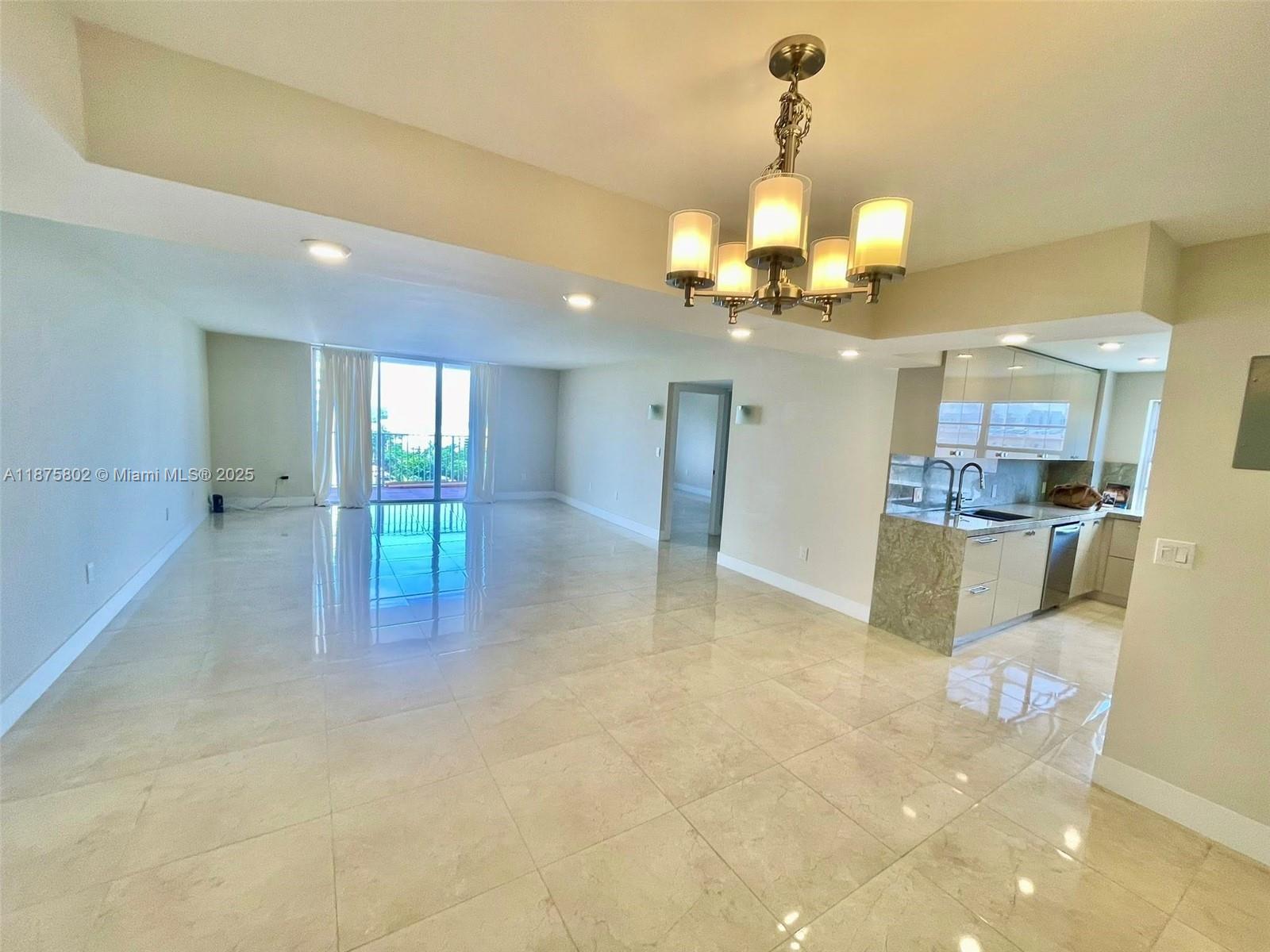2851 Northeast 183rd Street, Unit 802E Aventura, FL 33160 - Photo 4 of 37 a view of a kitchen and chandelier