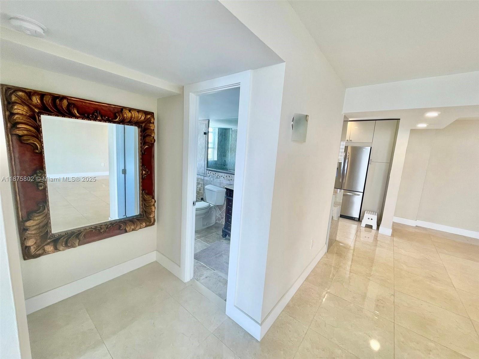 2851 Northeast 183rd Street, Unit 802E Aventura, FL 33160 - Photo 6 of 37 a view of a hallway with wooden floor and a bathroom