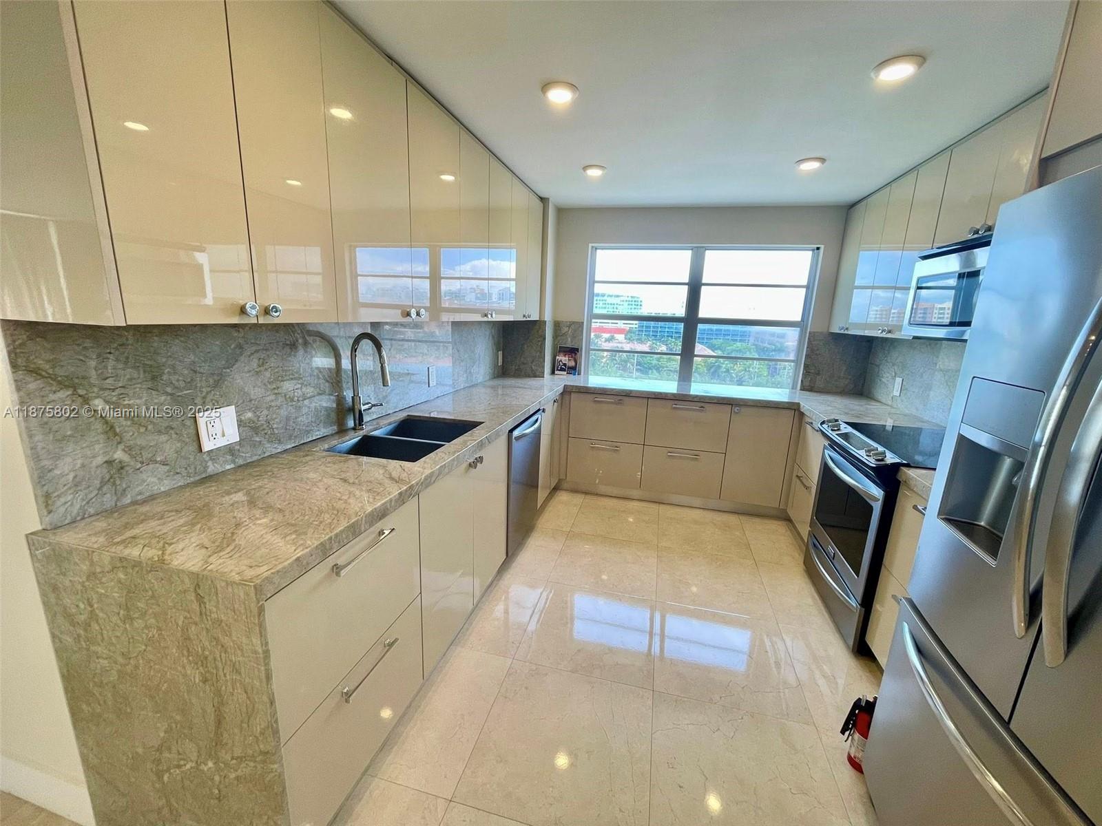 2851 Northeast 183rd Street, Unit 802E Aventura, FL 33160 - Photo 7 of 37 a kitchen with stainless steel appliances granite countertop sink stove and cabinets