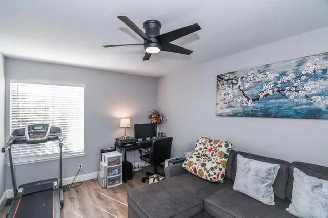 a living room with flat screen tv and a window