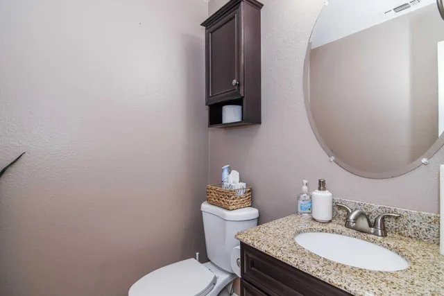 a bathroom with a sink a mirror and a toilet