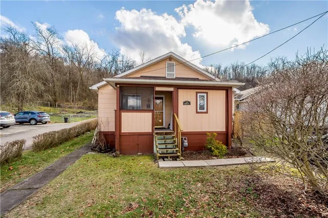 a front view of a house with garden