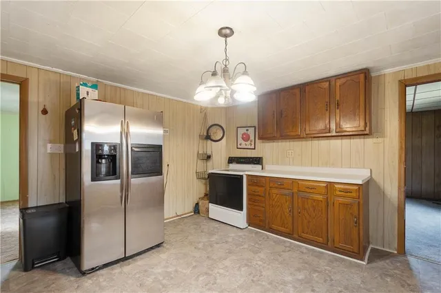 a kitchen with stainless steel appliances granite countertop a refrigerator and a sink