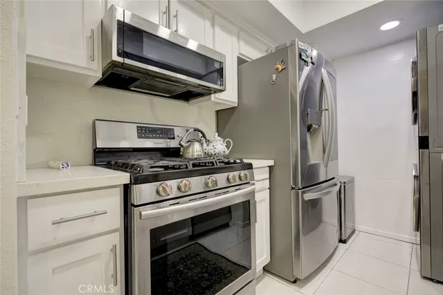 a kitchen with stainless steel appliances kitchen island granite countertop a sink and cabinets