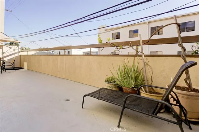 a dinning area with glass top table and chairs