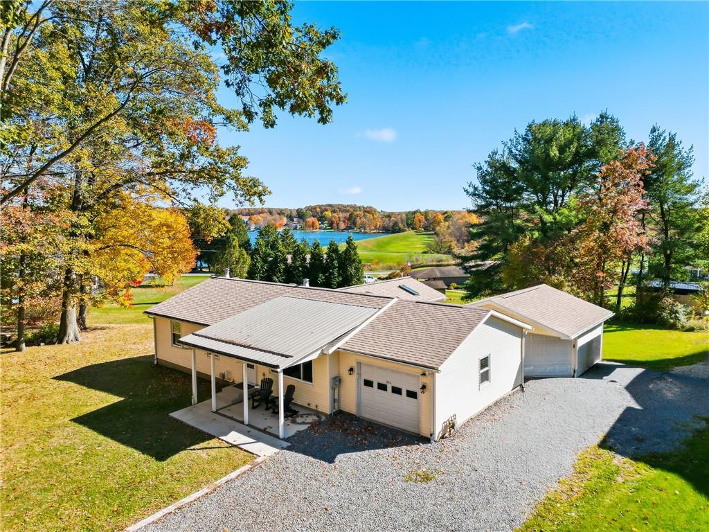 aerial view of a house with swimming pool and trees in the background