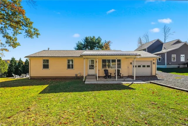 a front view of a house with patio and a garden